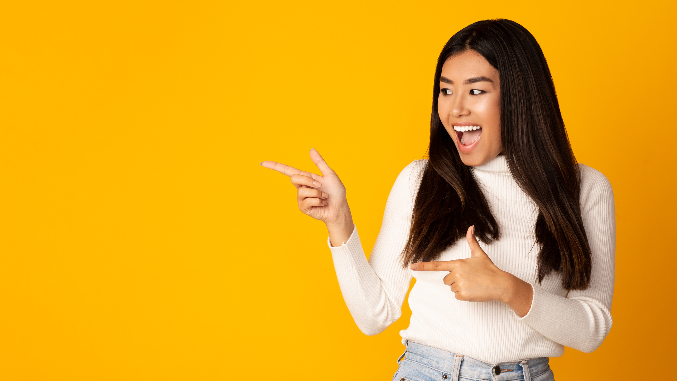 Great offer! Overjoyed girl pointing at empty space